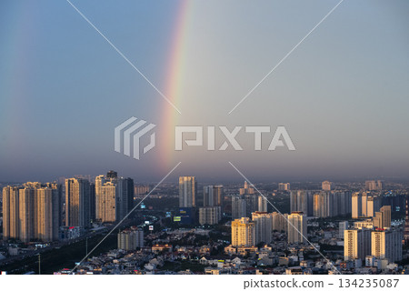 Rainbow is seen in the sky above a city Rainbow is seen in the sky above a city 134235087