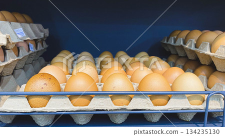 Fresh Brown Chicken Eggs in Cardboard Trays on Supermarket Shelf for Food, Nutrition, and Grocery Shopping Concept Fresh Brown Chicken Eggs in Cardboard Trays on Supermarket Shelf for Food, Nutrition, and Grocery Shopping Concept 134235130