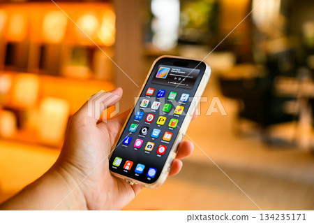 Operate a smartphone at a cafe Operate a smartphone at a cafe 134235171