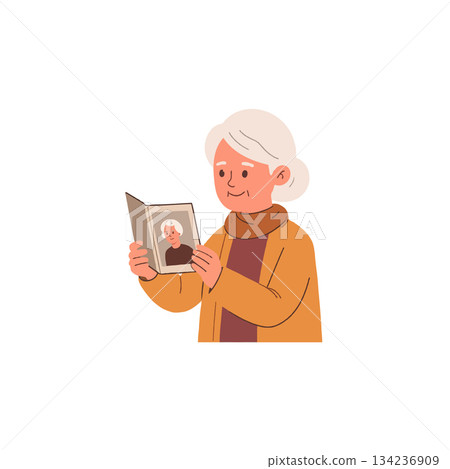 Nostalgic remembrance: elderly woman tenderly gazing at a cherished portrait photo from her past 134236909