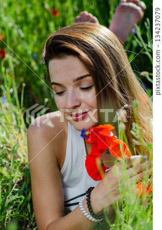 pretty woman in the field of poppies pretty woman in the field of poppies 134237079