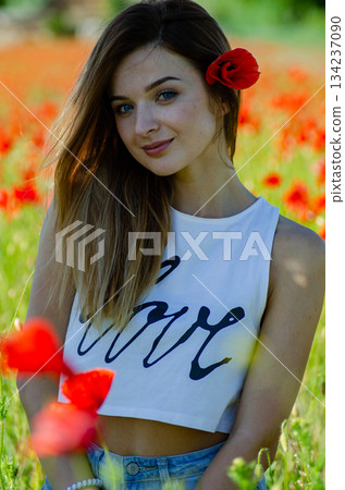 pretty woman in the field of poppies pretty woman in the field of poppies 134237090
