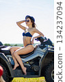 Sexy, slim, pretty, attractive girl in swimsuit on the ATV quad bike. ATV concept. 134237094
