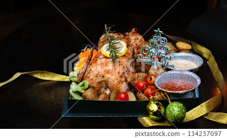 Christmas roast chicken with vegetables, sauces and holiday decoration Suitable for seasonal ads, festive menus, food catalogs, catering promotions and winter holiday visuals. 134237097