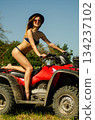 Sexy, slim, pretty, attractive girl in swimsuit on the ATV quad bike. ATV concept. 134237102