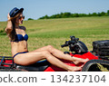 Sexy, slim, pretty, attractive girl in swimsuit on the ATV quad bike. ATV concept. 134237104