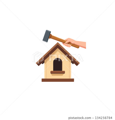 Hand holding a hammer over a birdhouse suggesting repair construction or building a new avian home 134238784