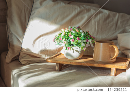 Breakfast in bed with coffee mug and potted plant on wooden tray 134239211
