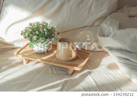 Breakfast in bed with coffee mug and potted plant on wooden tray 134239212