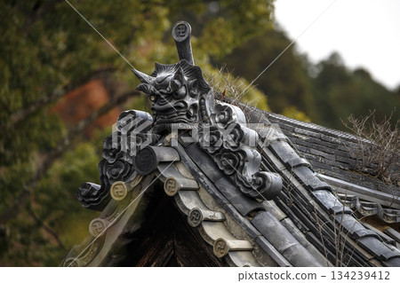 This Japanese traditional handcrafted Onigawara displays a mythical face designed to protect the building This Japanese traditional handcrafted Onigawara displays a mythical face designed to protect the building 134239412
