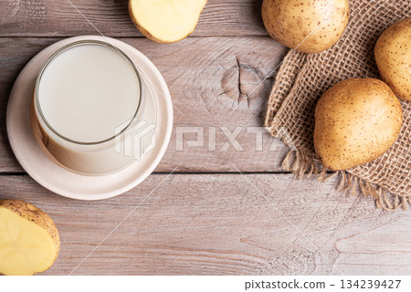 Vegan potato milk on wooden background Vegan potato milk on wooden background 134239427