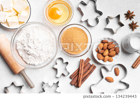 Christmas baking background with baking ingredients and cookie cutters 134239443