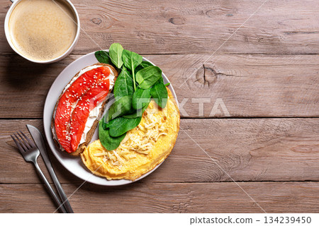 Healthy breakfast for two. Omelette, sandwich with salmon, spinach. 134239450
