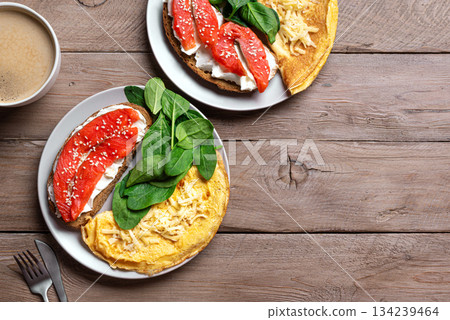 Healthy breakfast for two. Omelette, sandwich with salmon, spinach. Healthy breakfast for two. Omelette, sandwich with salmon, spinach. 134239464