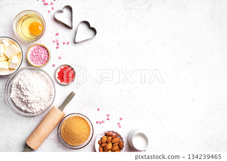 Valentine day baking background with heart shaped cookie cutters Valentine day baking background with heart shaped cookie cutters 134239465