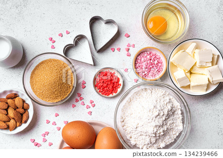 Valentine day baking background with heart shaped cookie cutters Valentine day baking background with heart shaped cookie cutters 134239466