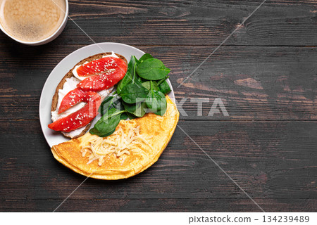 Healthy breakfast plate. Omelette, sandwich with salmon, spinach. Healthy breakfast plate. Omelette, sandwich with salmon, spinach. 134239489