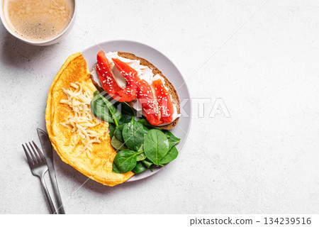 Healthy breakfast. Omelette, sandwich with salmon, spinach. Healthy breakfast. Omelette, sandwich with salmon, spinach. 134239516