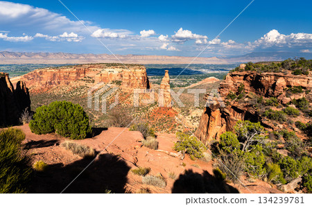 View of the iconic Independence Monument spire in Colorado National Monument. The Grand Valley and Book Cliffs are visible in the background View of the iconic Independence Monument spire in Colorado National Monument. The Grand Valley and Book Cliffs are visible in the background 134239781