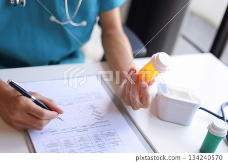 Doctor or authorized medical professional orders a specific medication for a patient to treat an illness or injury. Doctor or authorized medical professional orders a specific medication for a patient to treat an illness or injury. 134240570