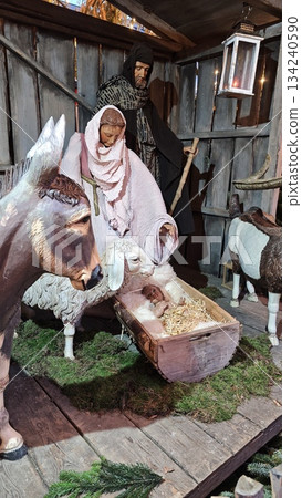 Traditional nativity scene with Mary, Joseph and baby Jesus in a wooden stable surrounded by farm animals. The image represents Christmas faith, spirituality, family unity and religious tradition Traditional nativity scene with Mary, Joseph and baby Jesus in a wooden stable surrounded by farm animals. The image represents Christmas faith, spirituality, family unity and religious tradition 134240590