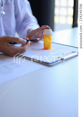 Doctor or General practitioner explain to patient how to use prescribed medicine correctly Doctor or General practitioner explain to patient how to use prescribed medicine correctly 134240706