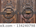 Antique wooden door detail with crown carving 134240798