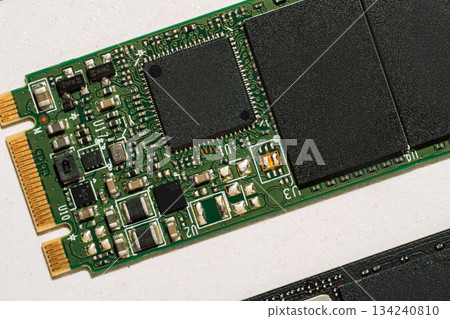 Macro of green M.2 SSD controller and electronic components 134240810