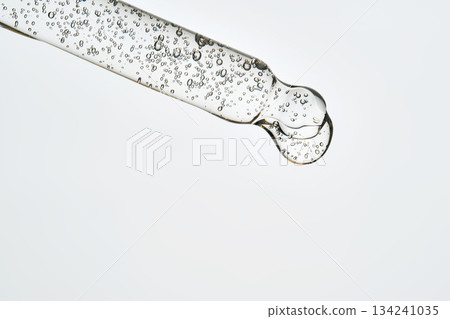 Cosmetic pipette dropping clear serum or hyaluronic acid gel Cosmetic pipette dropping clear serum or hyaluronic acid gel 134241035