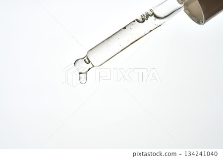 Cosmetic serum dropper applying essential liquid oil 134241040