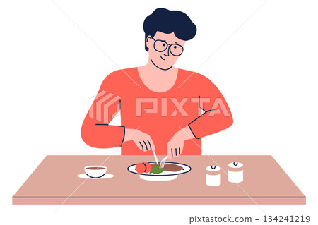 A man is eating a meal at a table A man is eating a meal at a table 134241219