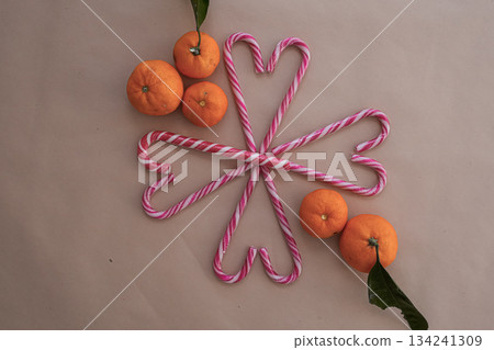 Tangerines and Heart Candy Canes on Neutral Background 134241309