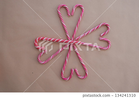 Heart-Shaped Candy Canes on Beige Background with Decorative Pattern 134241310