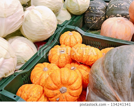 Fresh vegetables at farmers market. Close-up of fresh organic pumpkins, squash, cabbage and other autumn vegetables displayed in crates at local farmers market. Fresh vegetables at farmers market. Close-up of fresh organic pumpkins, squash, cabbage and other autumn vegetables displayed in crates at local farmers market. 134241341