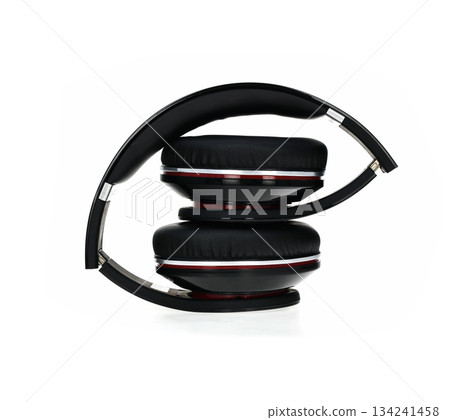 A pair of headphones with a black band and red accents 134241458