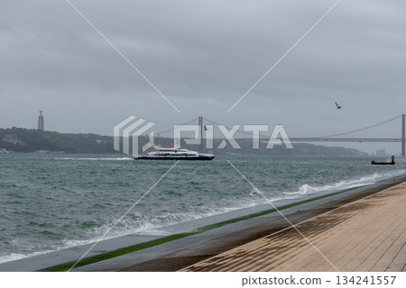 Bridge across blue bay to city beyond Lisbon panorama Portugal 134241557