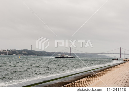 Bridge across blue bay to city beyond Lisbon panorama Portugal 134241558