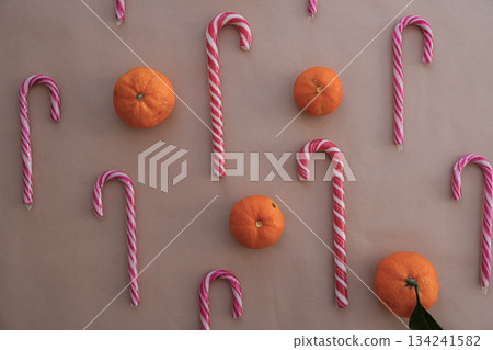 Scattered Heart Candy Canes and Tangerines on Beige Background Horizontal Scattered Heart Candy Canes and Tangerines on Beige Background Horizontal 134241582