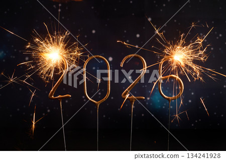 Sparkling New Year 2026. Glowing sparklers forming the number 2026 against a starry night sky Sparkling New Year 2026. Glowing sparklers forming the number 2026 against a starry night sky 134241928