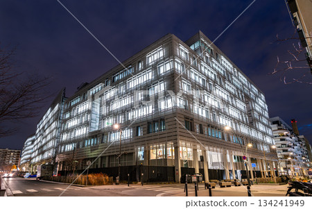 Saint-Ouen-sur-Seine, France - December 9, 2025: Modern headquarters of the Regional Council of Ile-de-France at night. Illuminated office building features glass facade and skybridge Saint-Ouen-sur-Seine, France - December 9, 2025: Modern headquarters of the Regional Council of Ile-de-France at night. Illuminated office building features glass facade and skybridge 134241949