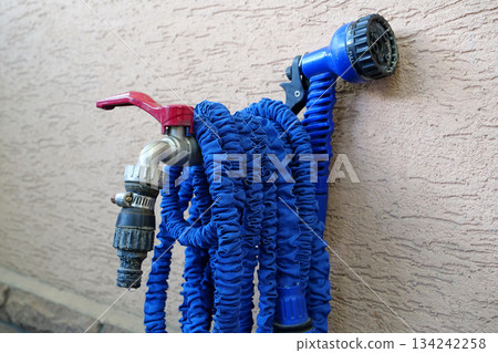 Outdoor tap for watering a garden plot. Water tap outside the building Outdoor tap for watering a garden plot. Water tap outside the building 134242258
