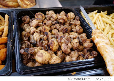 Fried champignon mushrooms. Foods in street fast food restaurant 134242282