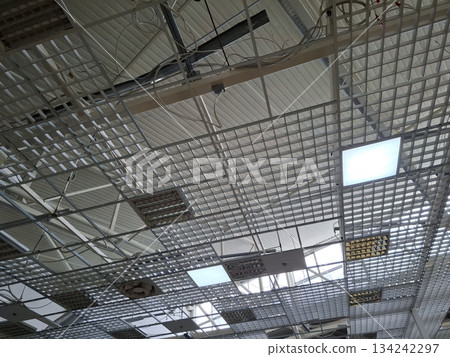 Ceiling in a shopping center with ventilators and electric lamps Ceiling in a shopping center with ventilators and electric lamps 134242297