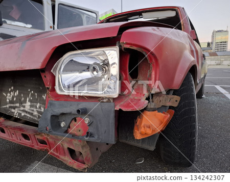 Red car after an accident. Passenger car in wreck condition after road accident 134242307