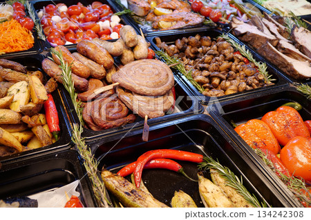 Meat sausages and frankfurters, fried potatoes, vegetables pickle 134242308
