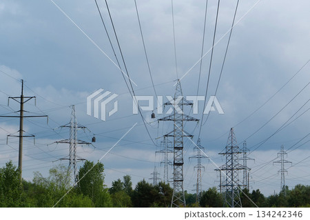 Power transmission towers and storm clouds Power transmission towers and storm clouds 134242346
