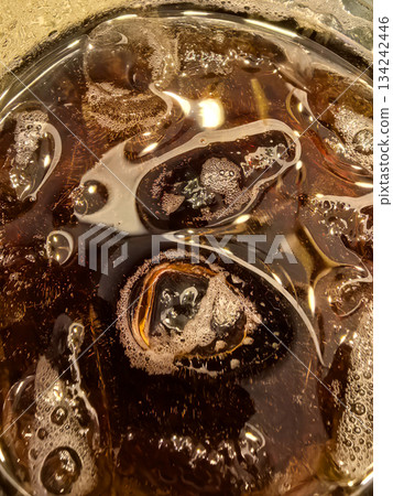 Refreshing whiskey cocktail with ice and cola served in a glass Refreshing whiskey cocktail with ice and cola served in a glass 134242446