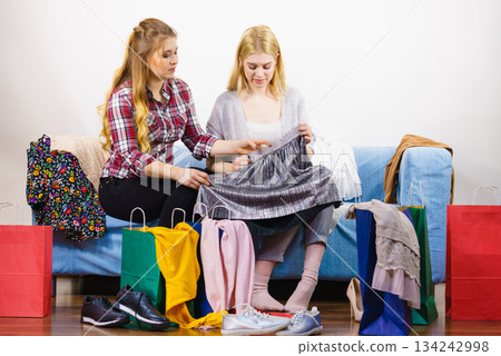 Two unhappy female friends after shopping Two unhappy female friends after shopping 134242998