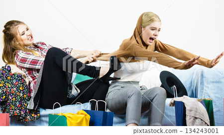 Two women arguing over sweater Two women arguing over sweater 134243001