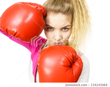 Woman wearing boxing gloves Woman wearing boxing gloves 134243068